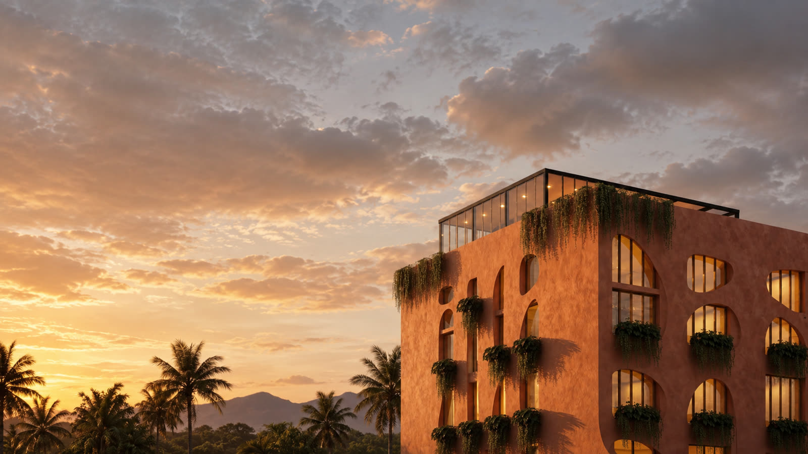 Ananta Canggu's curved terracotta facade at golden hour, arched windows with cascading greenery on every floor